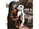 This Beduin woman is spinning yarn from a fleece as she walks. An early photograph.